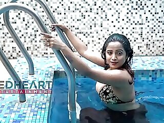 Lively Desi lady splashing around in pool